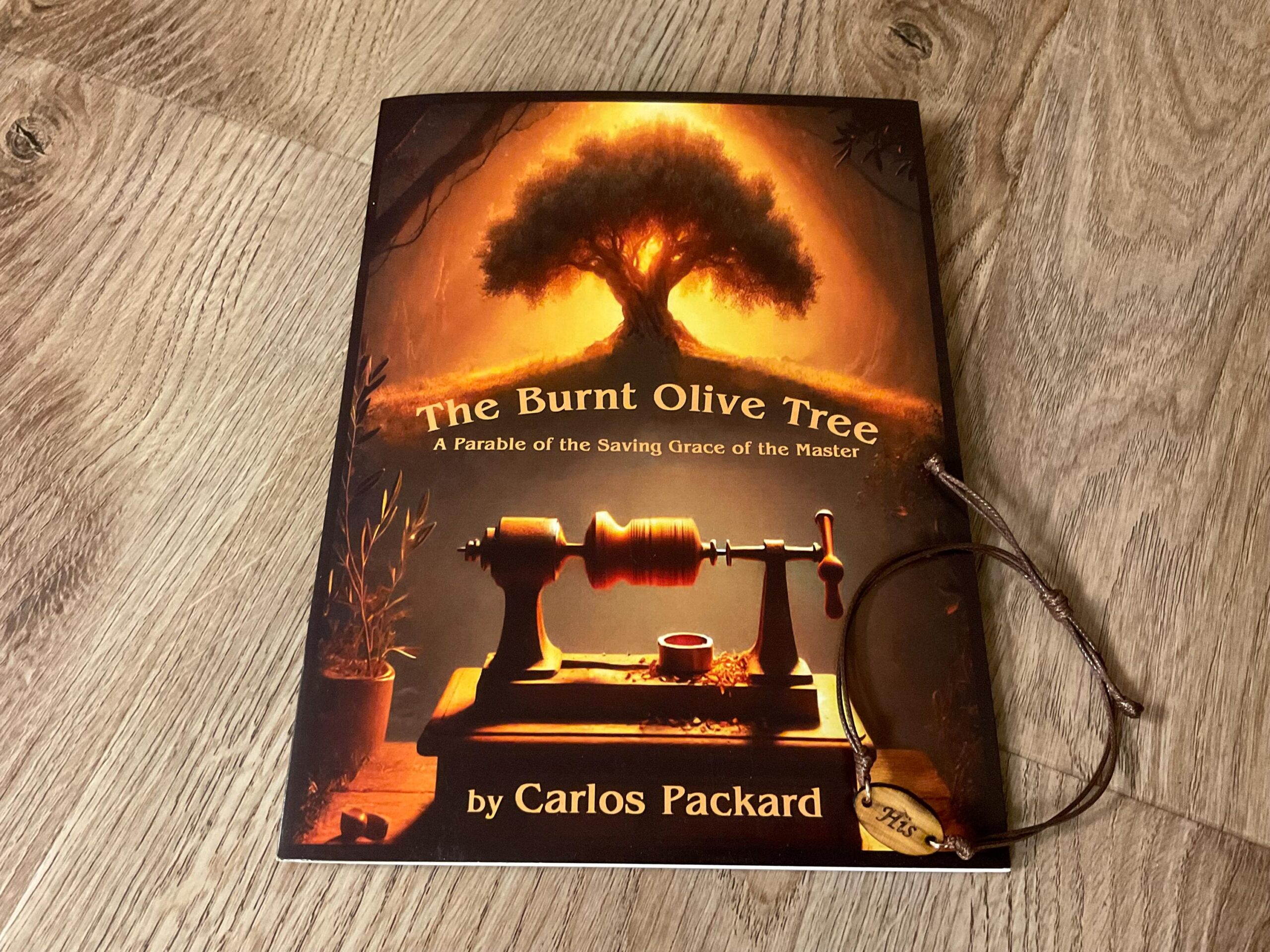 The Burnt Olive Tree: A Parable. Paperback booklet and Engraved bracelet made with olive wood from the Burnt Tree of Gethsemane
